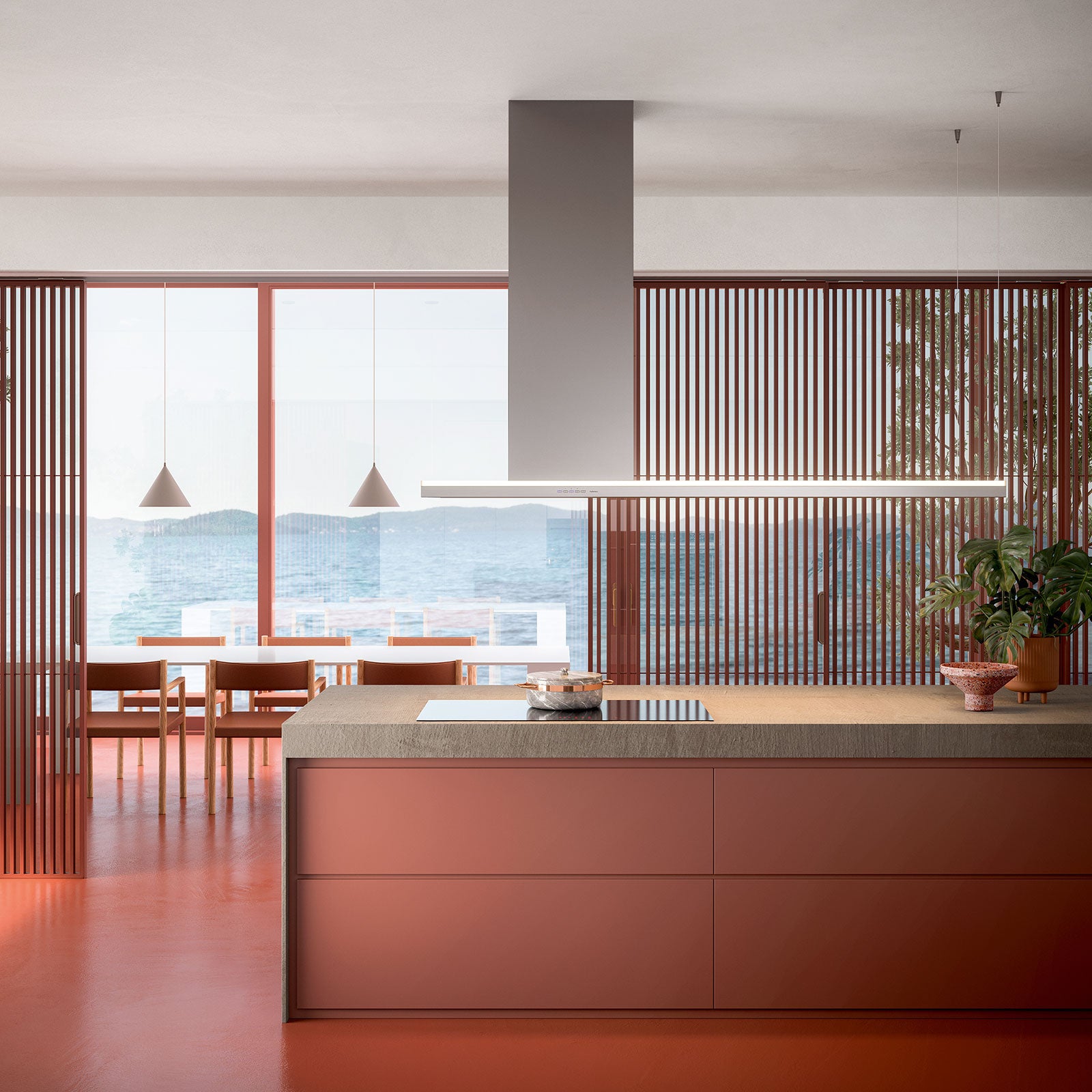 Campana de isla Falmec Lumen 175 instalada sobre isla en cocina de diseño con vista al mar