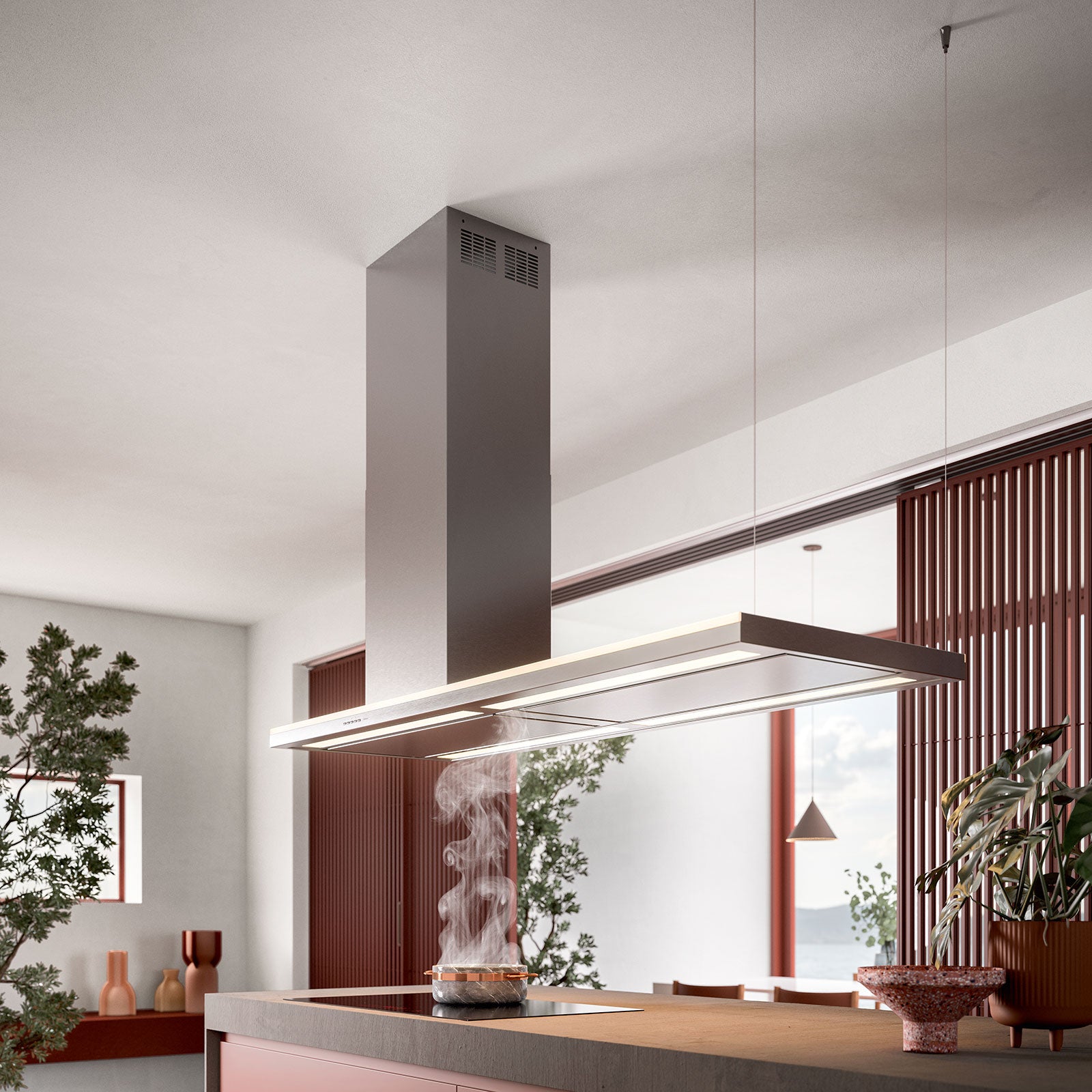 Campana lineal Falmec Lumen 175 suspendida sobre isla en cocina contemporánea